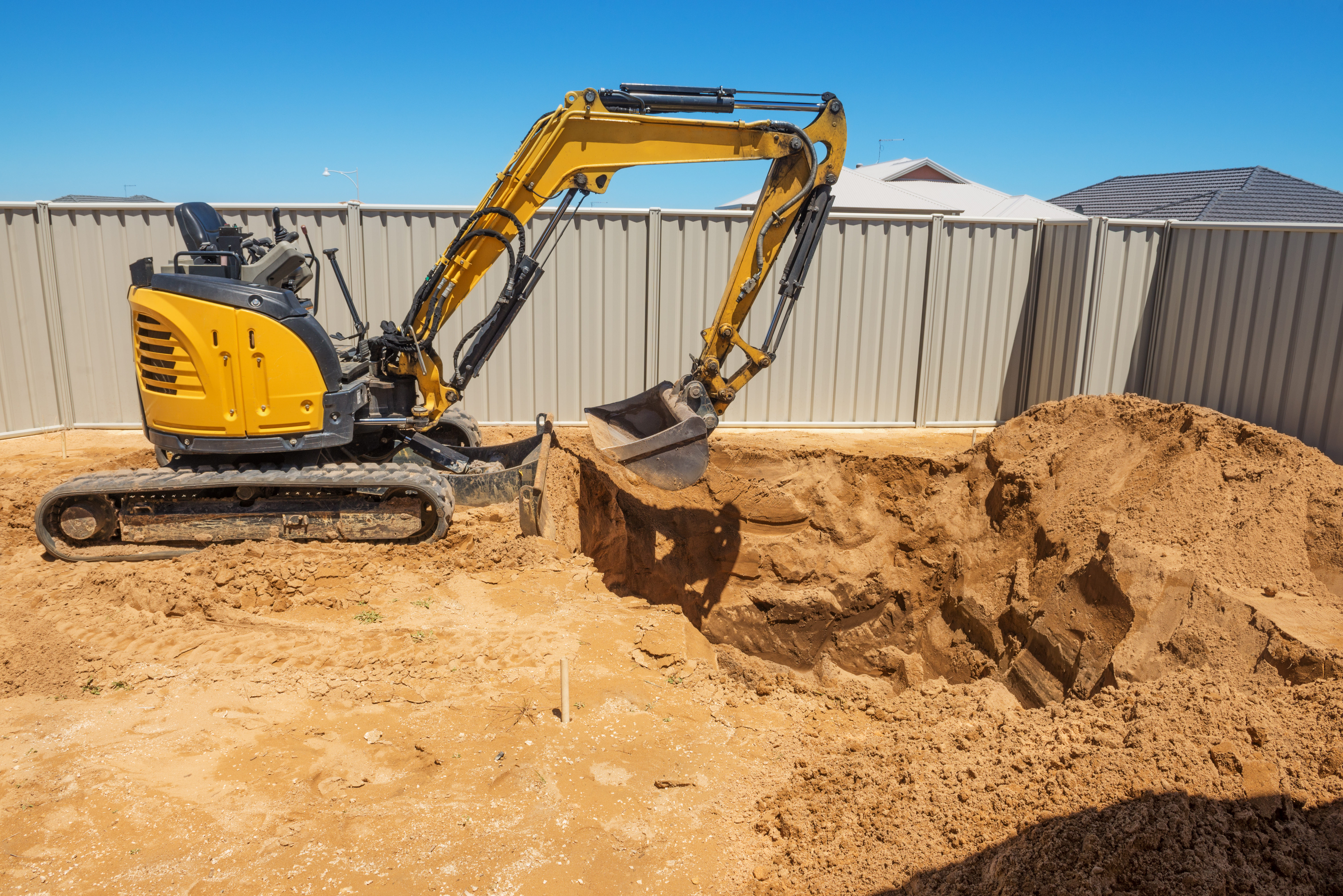 excavator breaking ground at a construction site